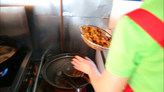 Freshly fried chicken taken out of the oil