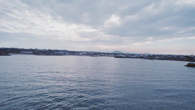 Coastal town with calm sea and cloudy sky