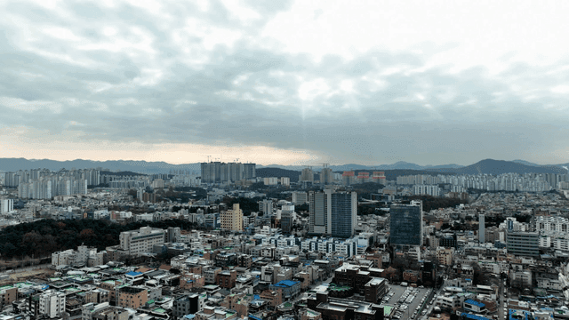 City landscape spread out under cloudy sky