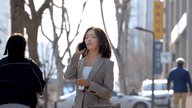Working woman walking through city street