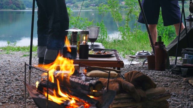 Peaceful lakeside campsite with bonfire