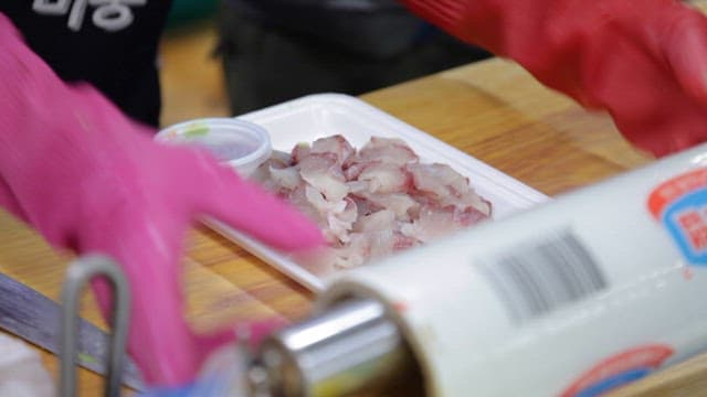 Wrapping Fresh Fish Slices in a Restaurant