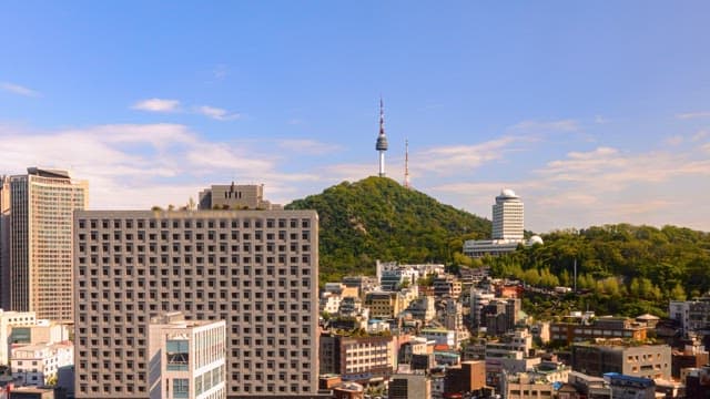 Cityscape with mountain and tower during sunset