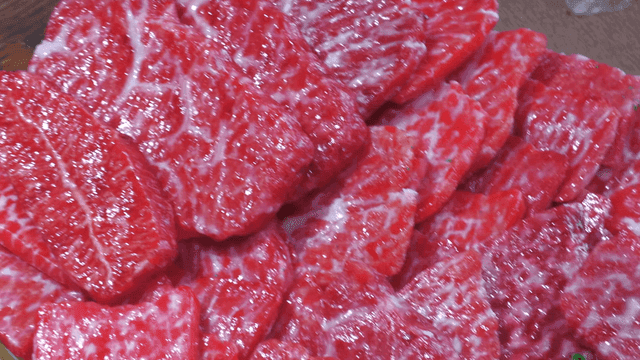 Freshly sliced marbled beef on a tray