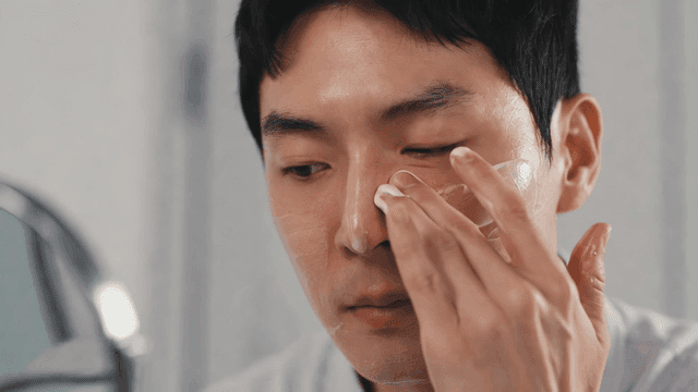 Man applying cream to his face