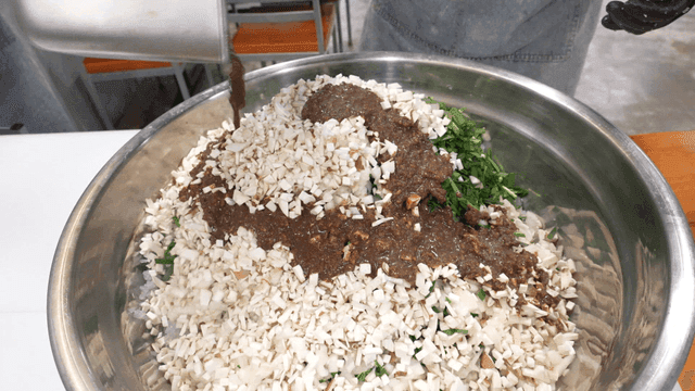 Dumpling filling mixed in large bowl
