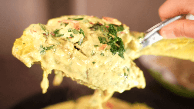 Creamy Mansaf with herbs, tongs for lifting lamb leg