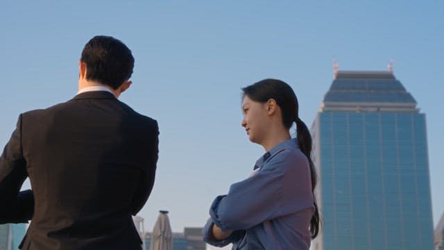 Two people discussing on a rooftop