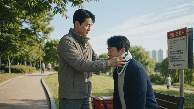 Man providing first aid to patient wearing neck brace in park