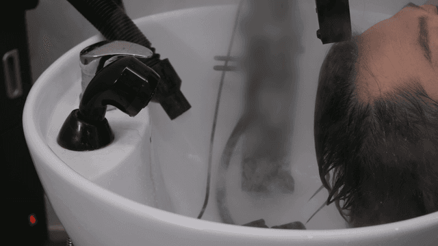 Person getting their hair washed at beauty salon