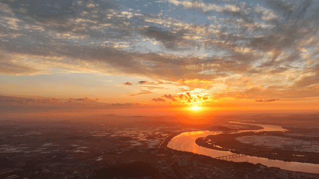 Sunset over a winding river and fields