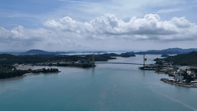 Scenic bridge over calm sea.