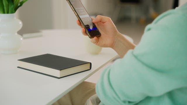 Person Using a Smartphone Indoors