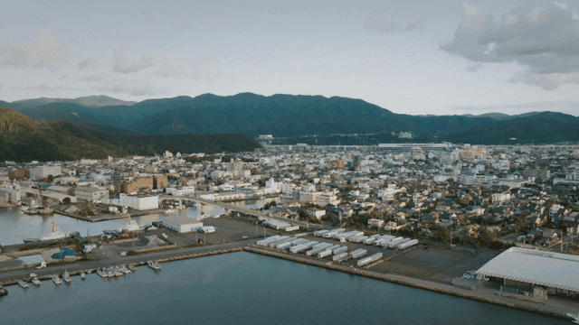 Coastal city with mountains in the background
