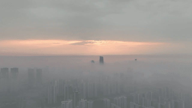A city skyline shrouded in morning fog