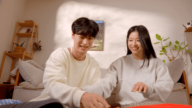 Happy couple folding clothes together