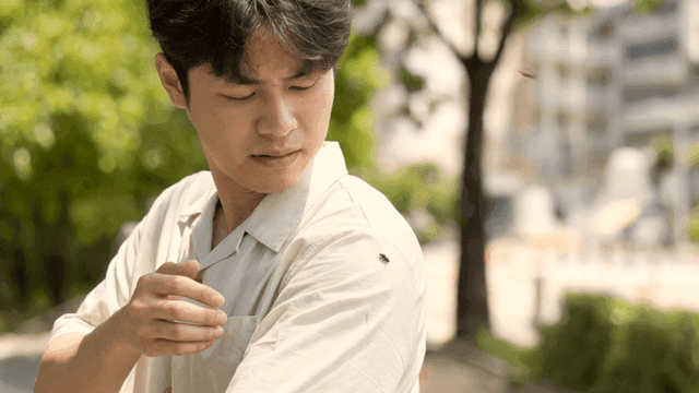 Man shaking off bug