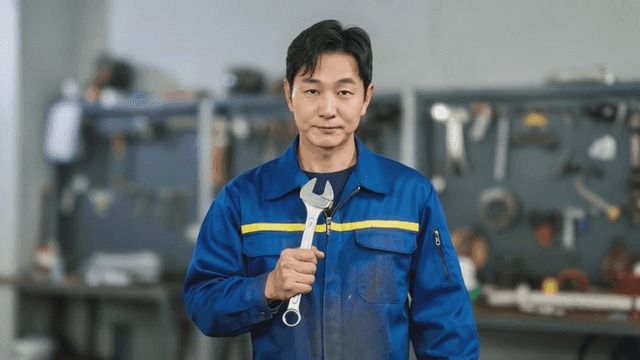 Mechanic holding a wrench in a workshop
