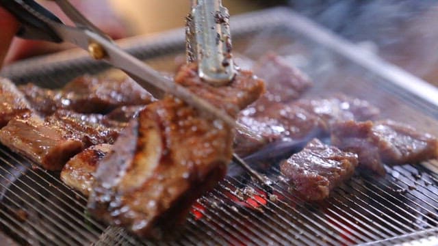 Grilled Pork Ribs Sizzling on a Grill