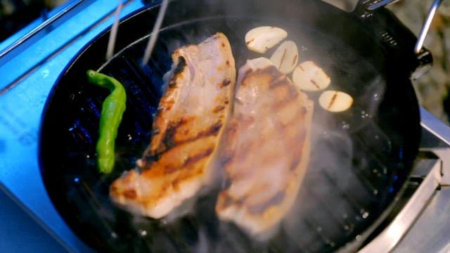 Grilling pork belly with garlic and pepper