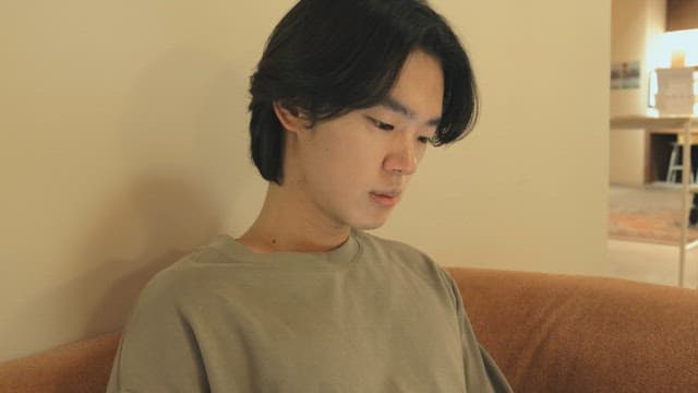 Young man sitting on a sofa indoors