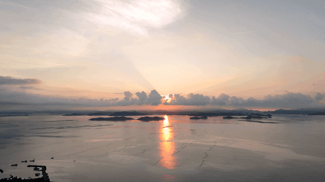 Sunset over a calm sea with islands
