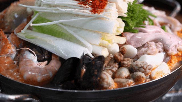 Monkfish seafood stew with boiling seafood and vegetables