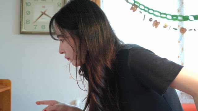 Woman choosing a book from a bookshelf