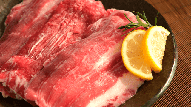 Fresh raw meat with lemon slices