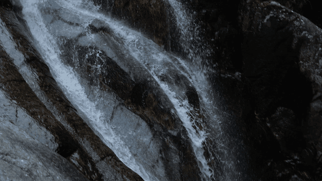 A cascading waterfall over rocky cliffs