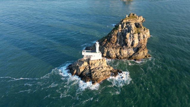 Lighthouse on a rocky island in the sea