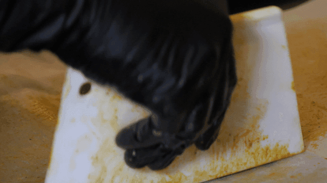 Duchonku filling rolled into circle while wearing gloves