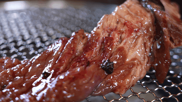 Marinated short ribs grilling on barbecue