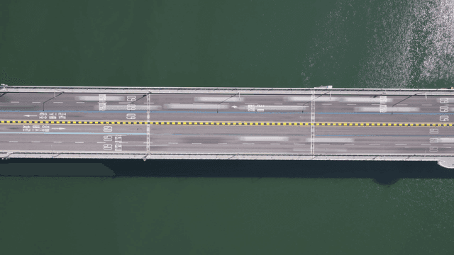 Aerial view time-lapse of bridge over river