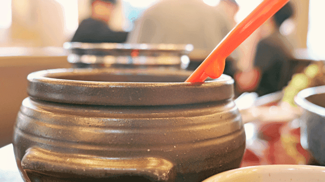 Jar with red ladle at restaurant