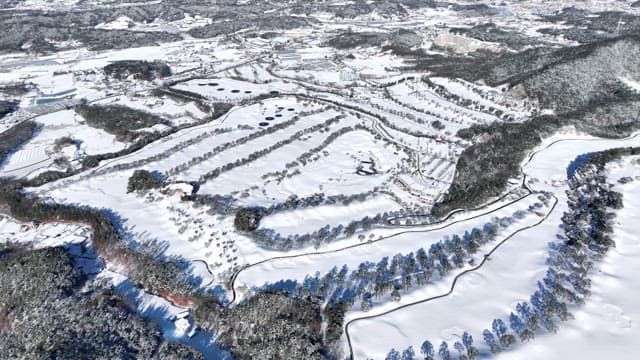 Snow-covered landscape with winding paths