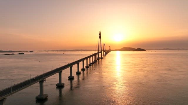 Bridge stretching over the sea at sunset