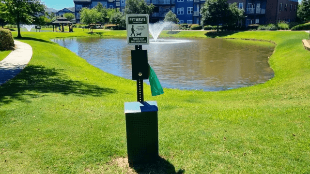 Pet waste station by a pond in a park