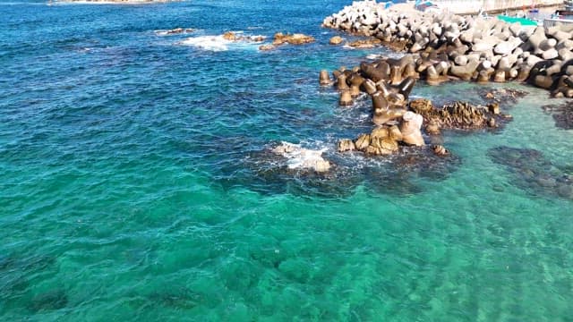 Coastal view with clear blue waters and rocks