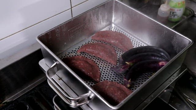 찜기에 육만두와 가지를 찌는 모습