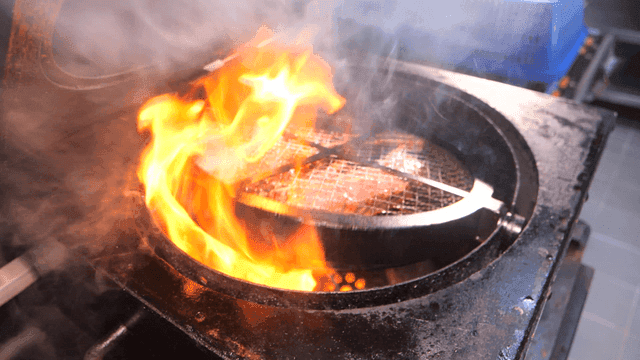Tomahawk steak grilled on rotating grill
