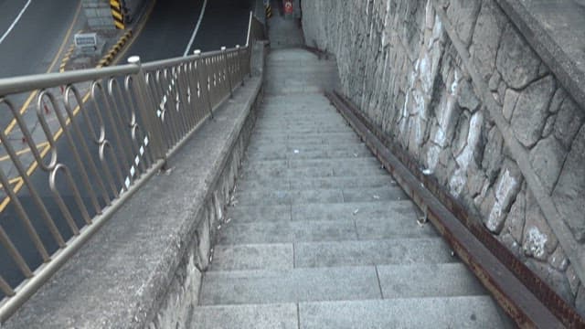 Entrance and stairs of the crowded Jahamun Tunnel during the day