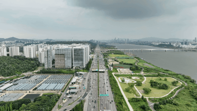 Aerial view of a city with a river and highway