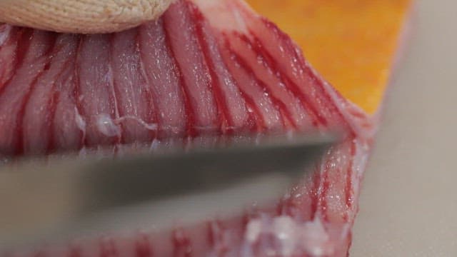 Close-up of tingray being sliced with a knife