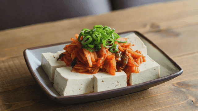 Tofu topped with kimchi and green onions