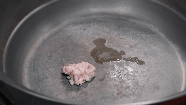 Adding ingredients to a pot for cooking