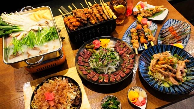 Table generously laid out with a variety of Japanese cuisine