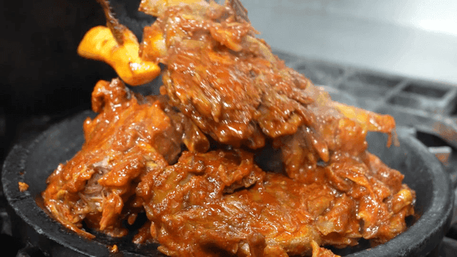 Spicy crunchy braised pork ribs served on hot plate