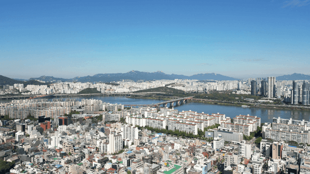 Expansive riverside skyline unfolding beyond the city