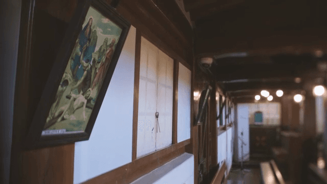 Quiet cathedral hallway with paintings hanging on it